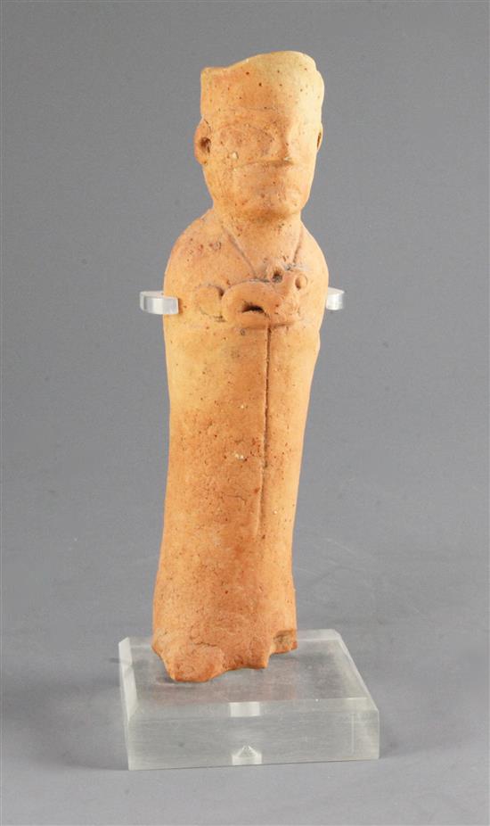 A Chinese red pottery figure of a man holding an animal, probably Song dynasty, 25cm